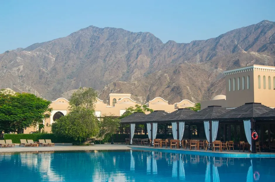 Hotel pool with mountains in the background at a resort